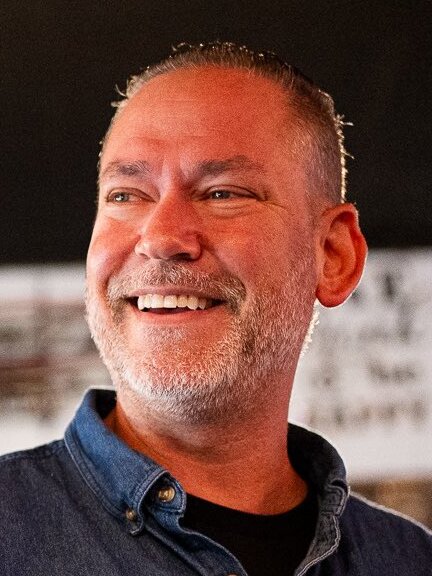 Dan Osborn smiling at a campaign event in rural Nebraska
